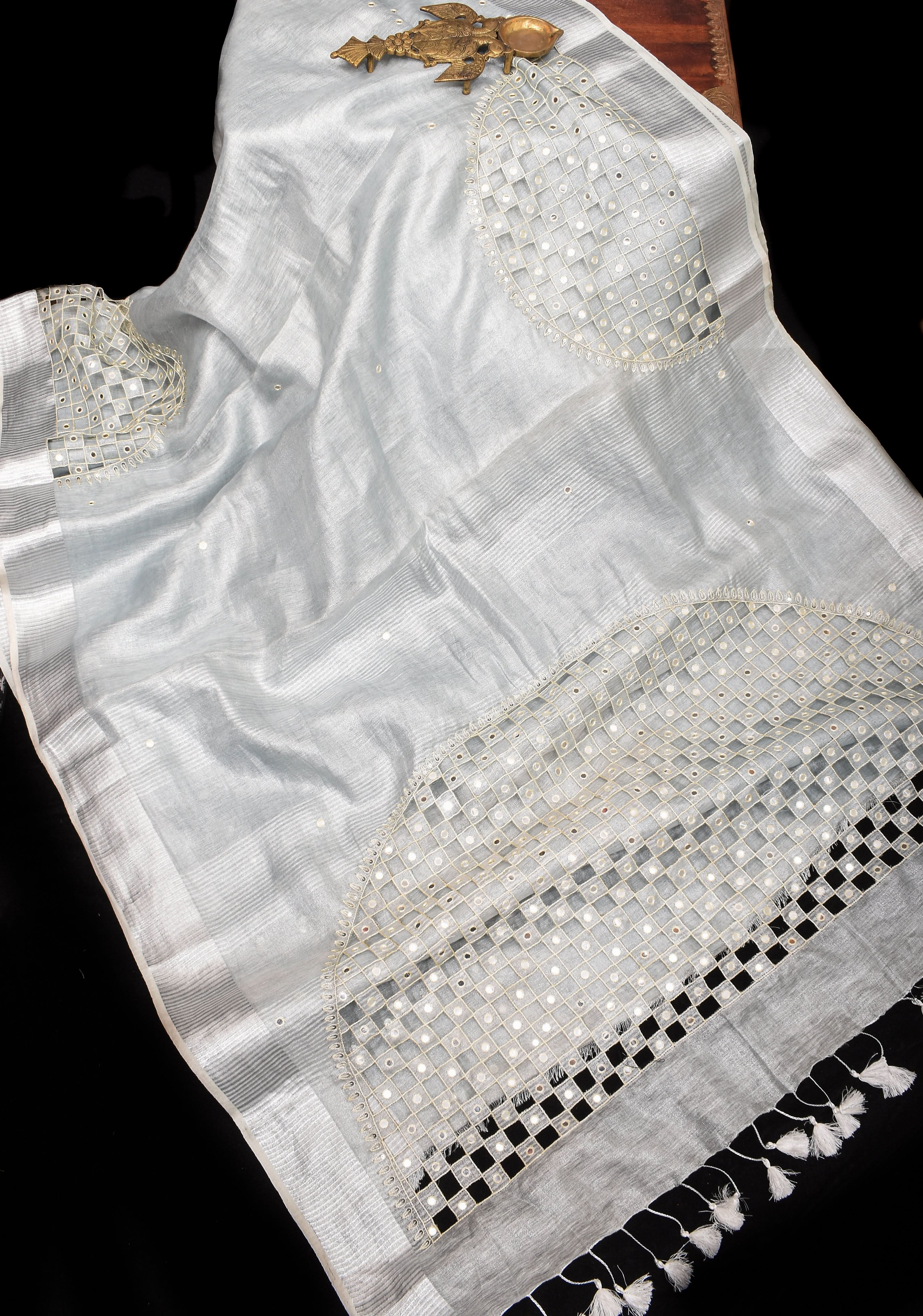 Cutwork and Mirror Work Tissue Linen Saree in White Silver with dramatic tassels | Shobitam